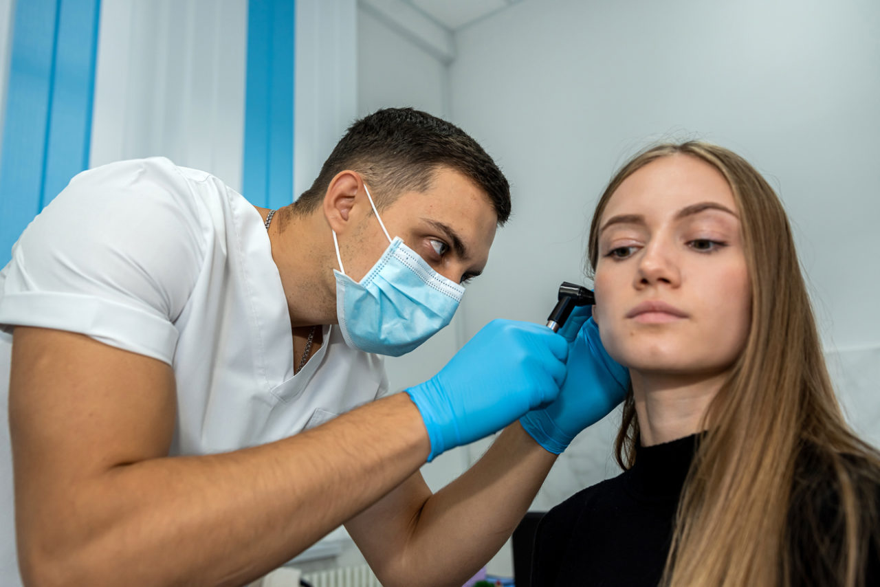 Doctor inspecting patient's ear